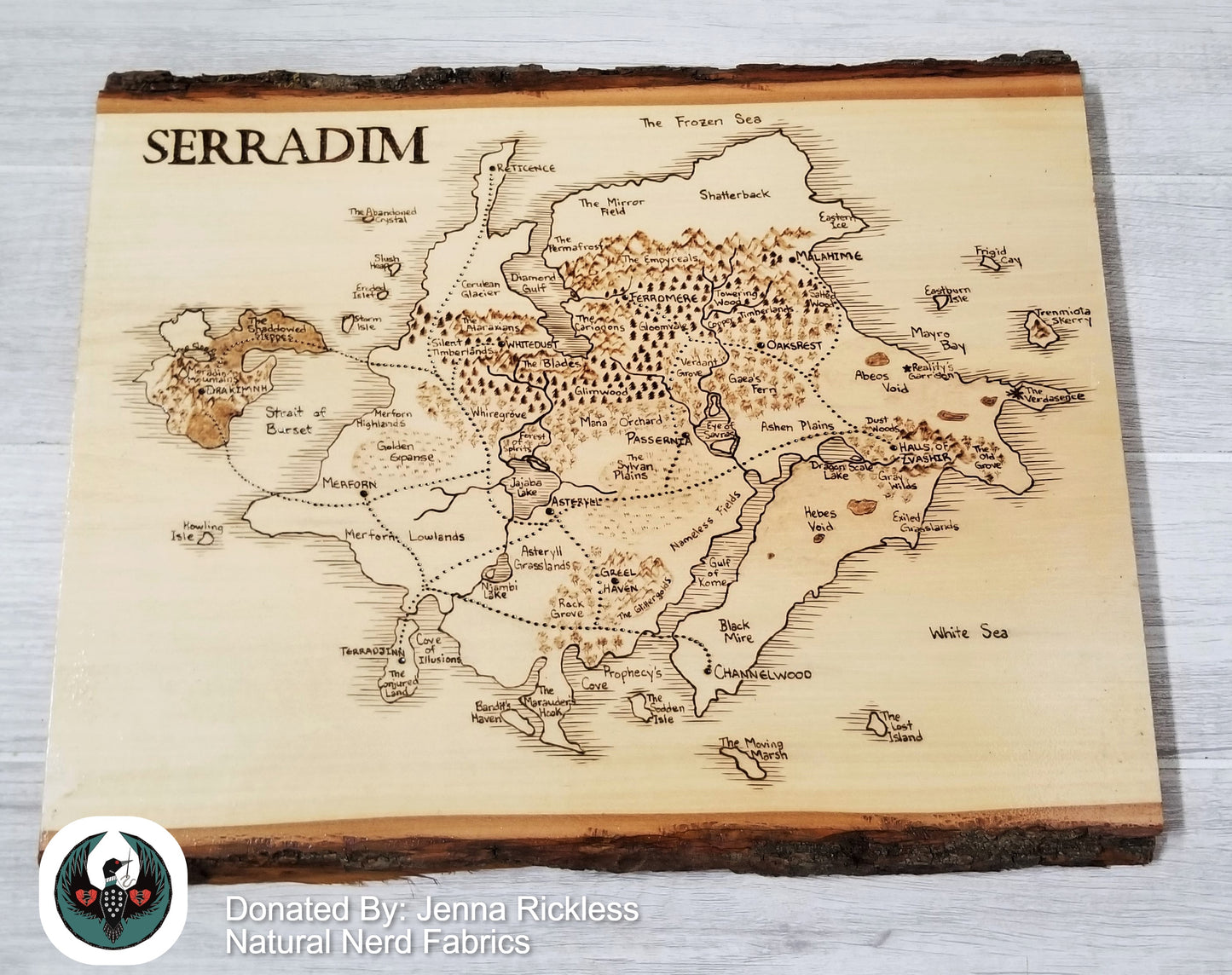 Wooden map of Serradim with engraved details on a wooden board