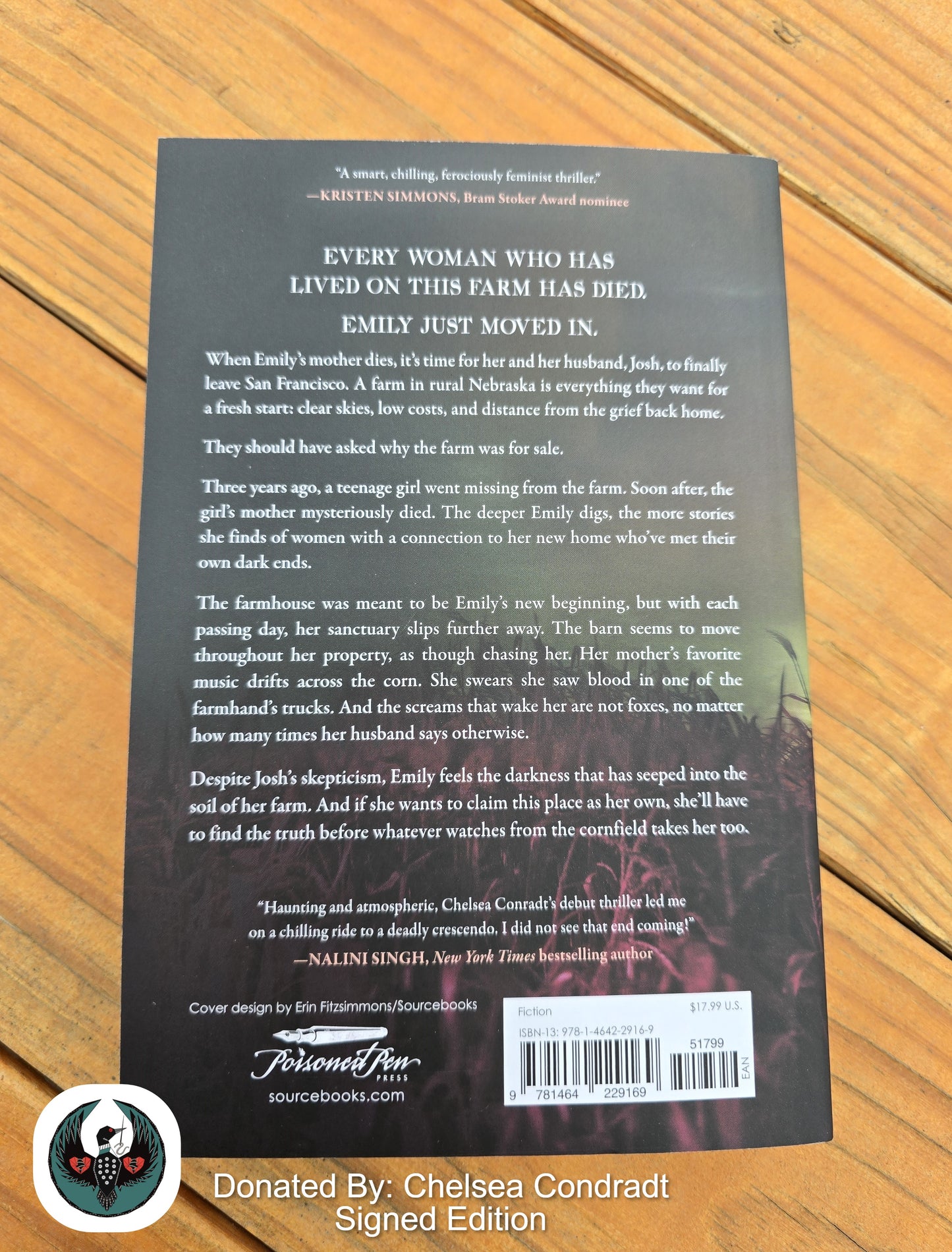 Back cover of a book with text and a barcode on a wooden surface