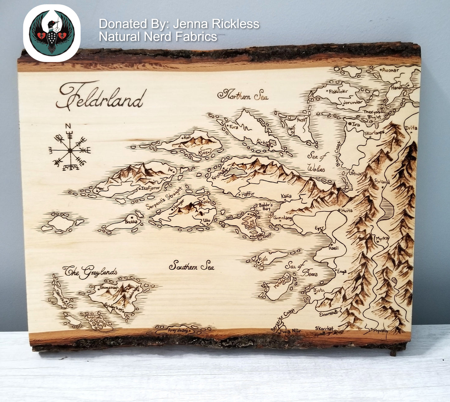 Wooden map of Felderland with engraved details on a gray background