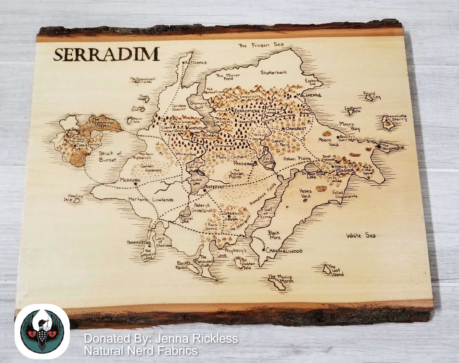Wooden map of Serradim with engraved details on a wooden board