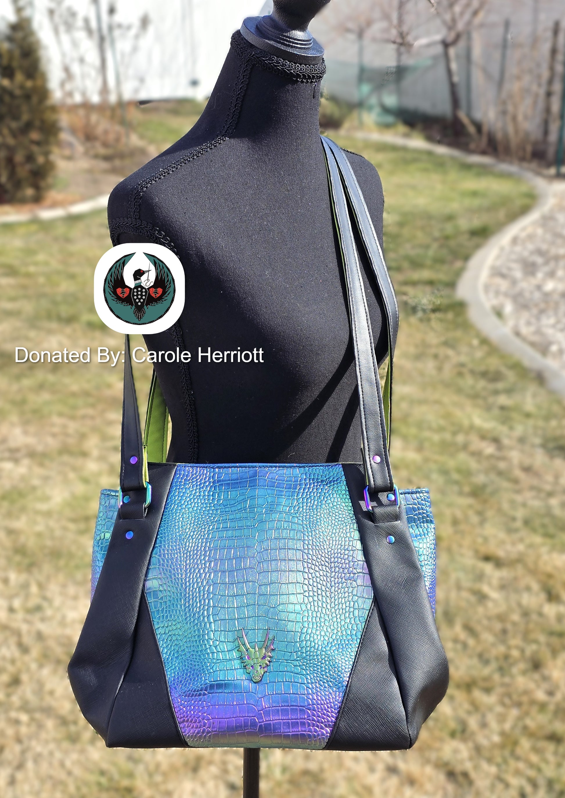 large crossbody bag with black and irridescent dragon scale vinyl and rainbow hardware on a mannequin