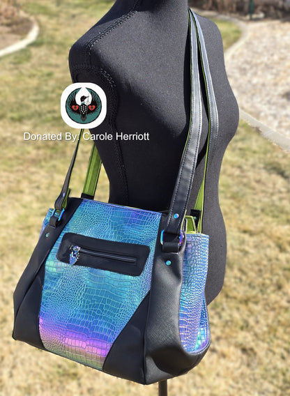 large crossbody bag with black and irridescent dragon scale vinyl and rainbow hardware on a mannequin