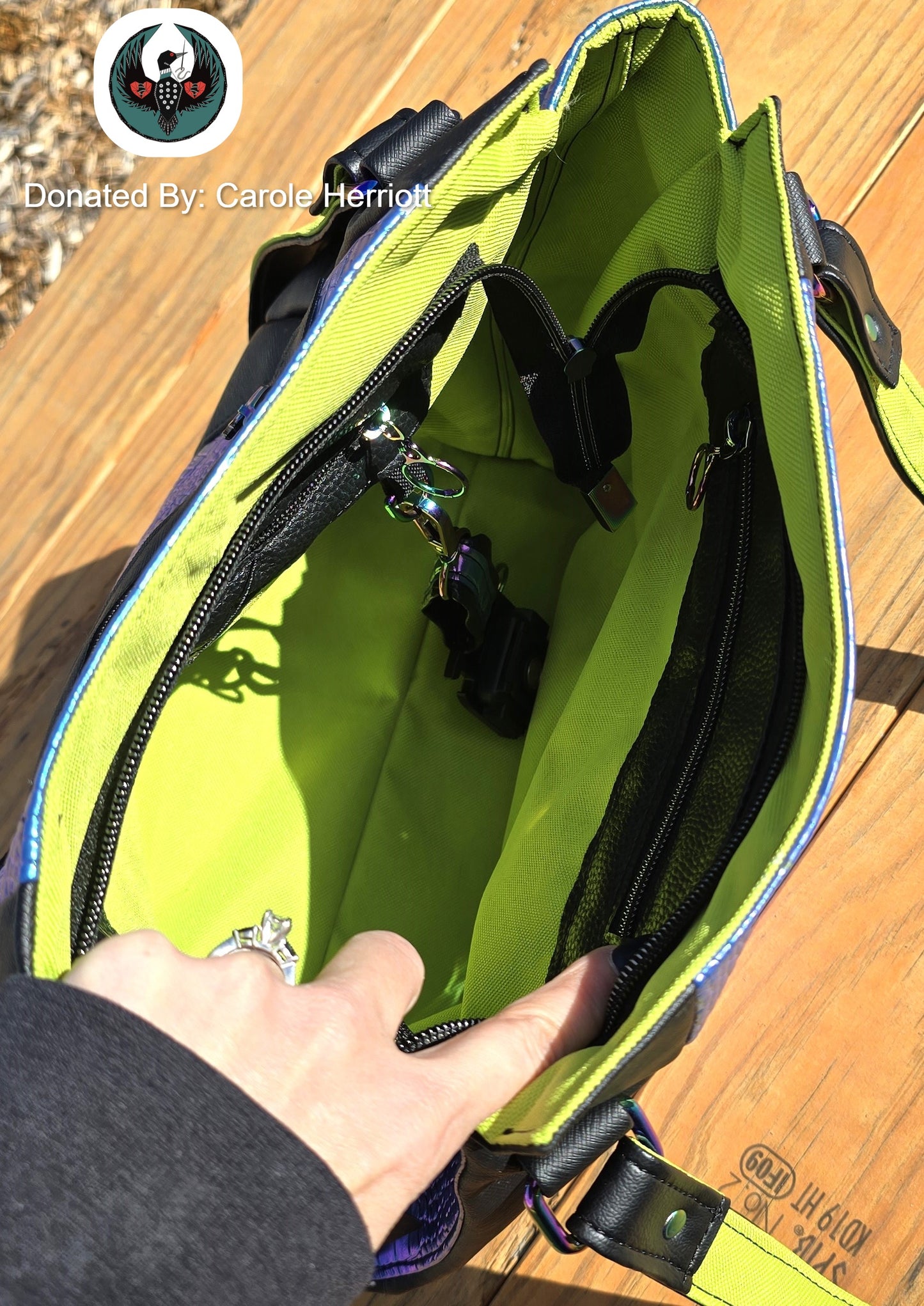 hand holding open a handbag to show a lime green interior