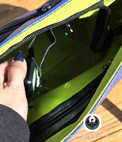 close up of an interior of a handbag with a flashlight attachment for seeing things in the bottom of a dark bag
