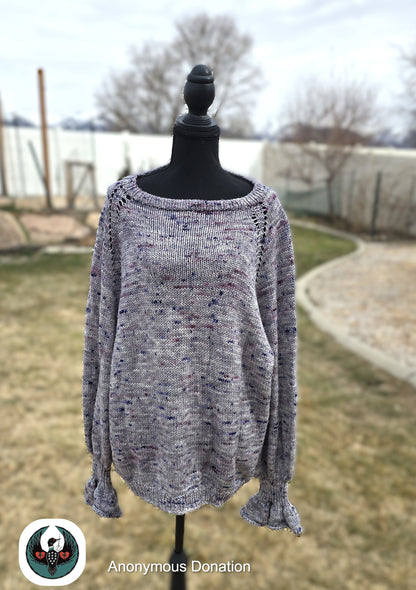 Gray knitted sweater on a mannequin outdoors with a blurred background