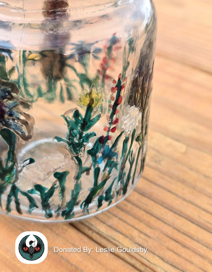 close up of a glass jar painted with wildflowers