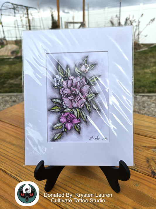 pink Floral drawing on a white card with a black stand, outdoors.