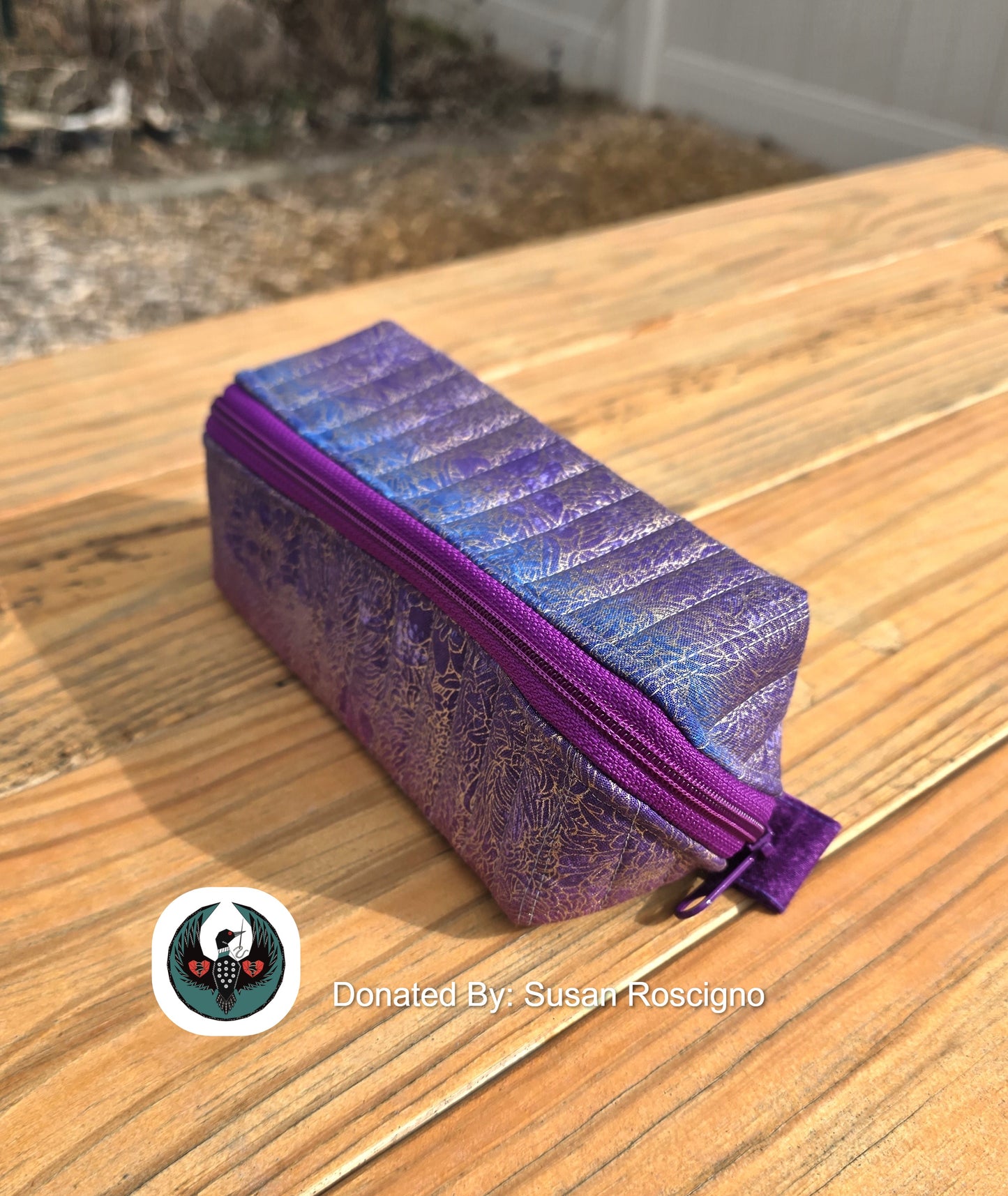 Purple prism zipper pouch on a wooden surface